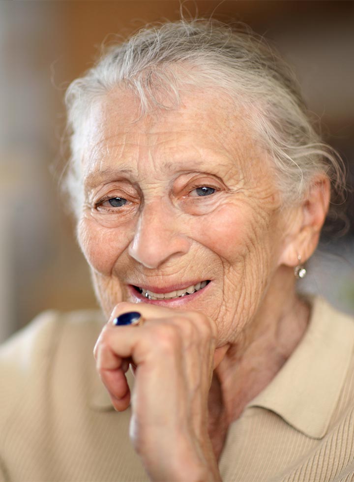 Photo of older lady smiling at camera
