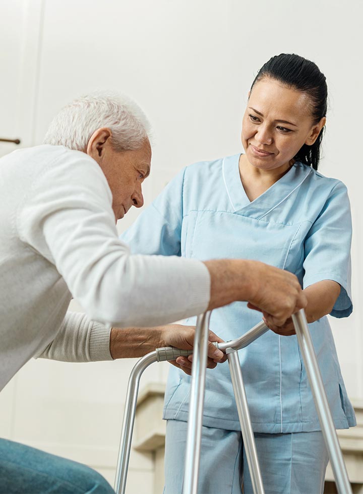 Photo of man with walker and nurse