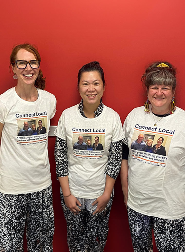 Photo of three smiling women wearing Connect Local t-shirts