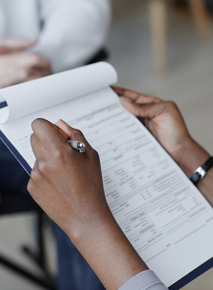 Photo of hands filling in a form