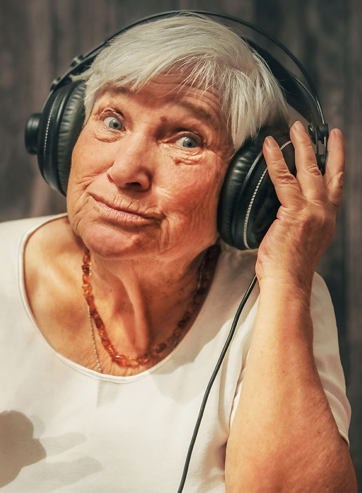 Photo of mature woman wearing headphones