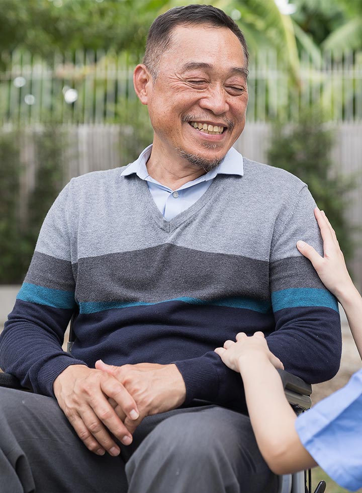 Photo of man in wheelchair with nurse