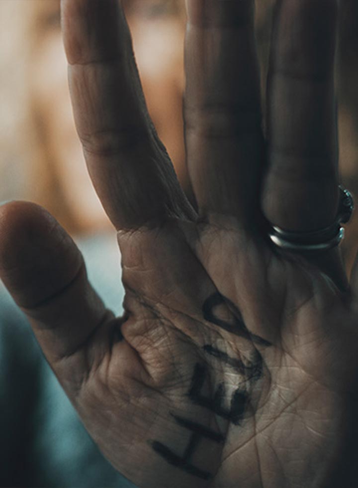 Photo of elderly hand with help written on the palm