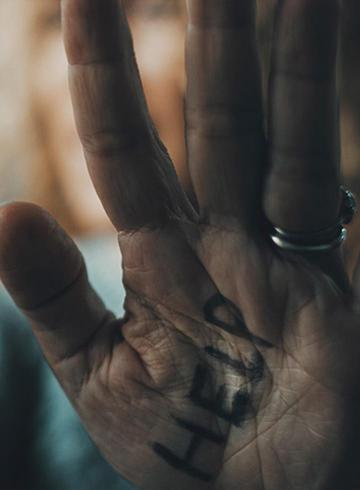 Photo of elderly hand with help written on the palm