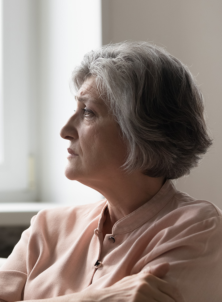Image of a seated, older woman in profile