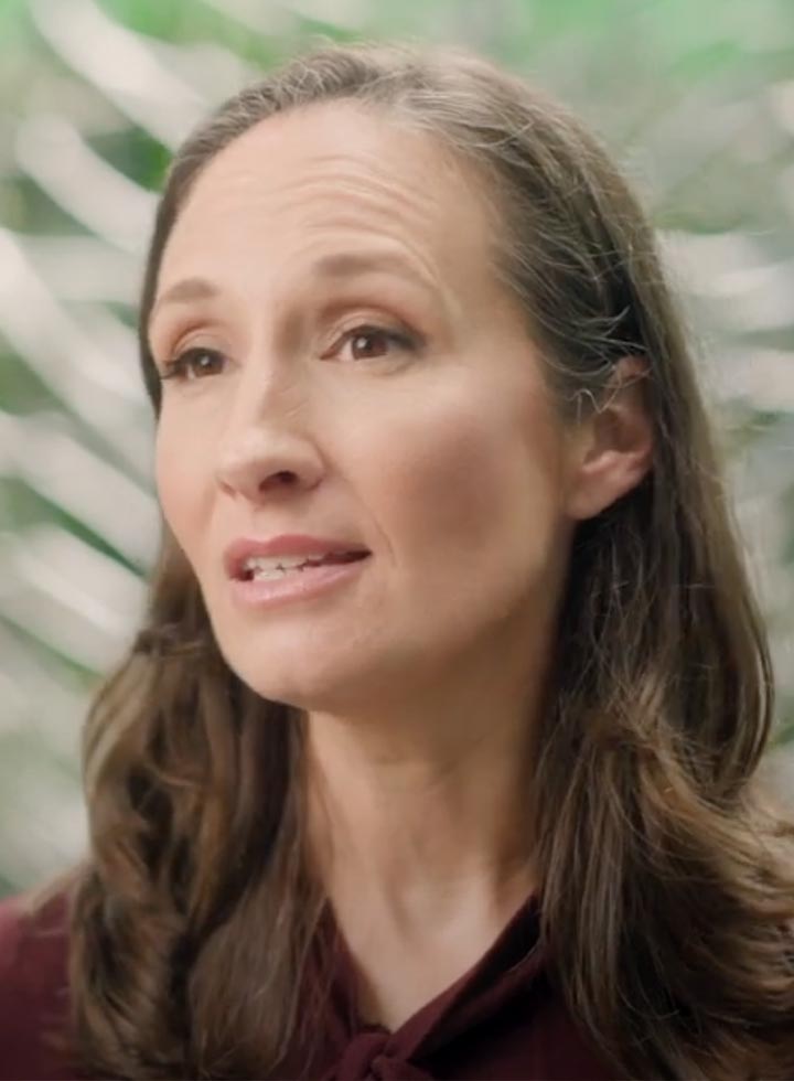 Photo of woman speaking on a video still
