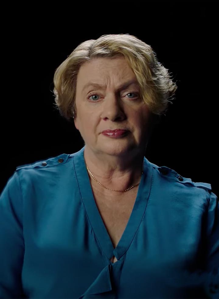 Photo of a woman in a teal silk shirt