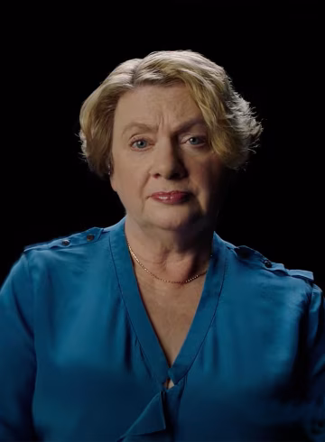 Photo of a woman in a teal silk shirt