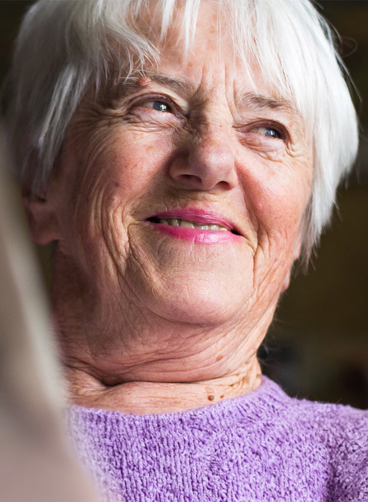 Photo of smiling woman in purple jumper