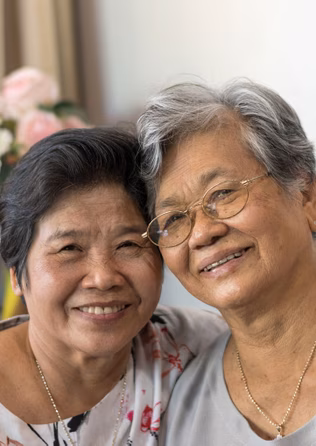 Two elderly women embracing