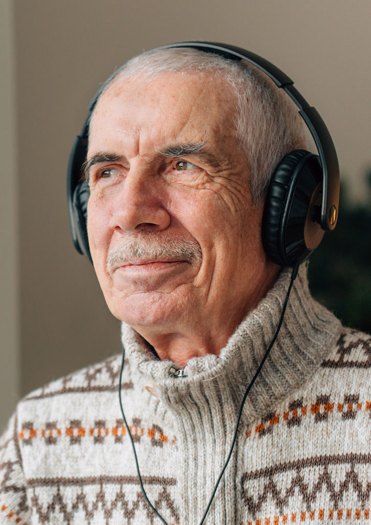 Senior man with headphones on
