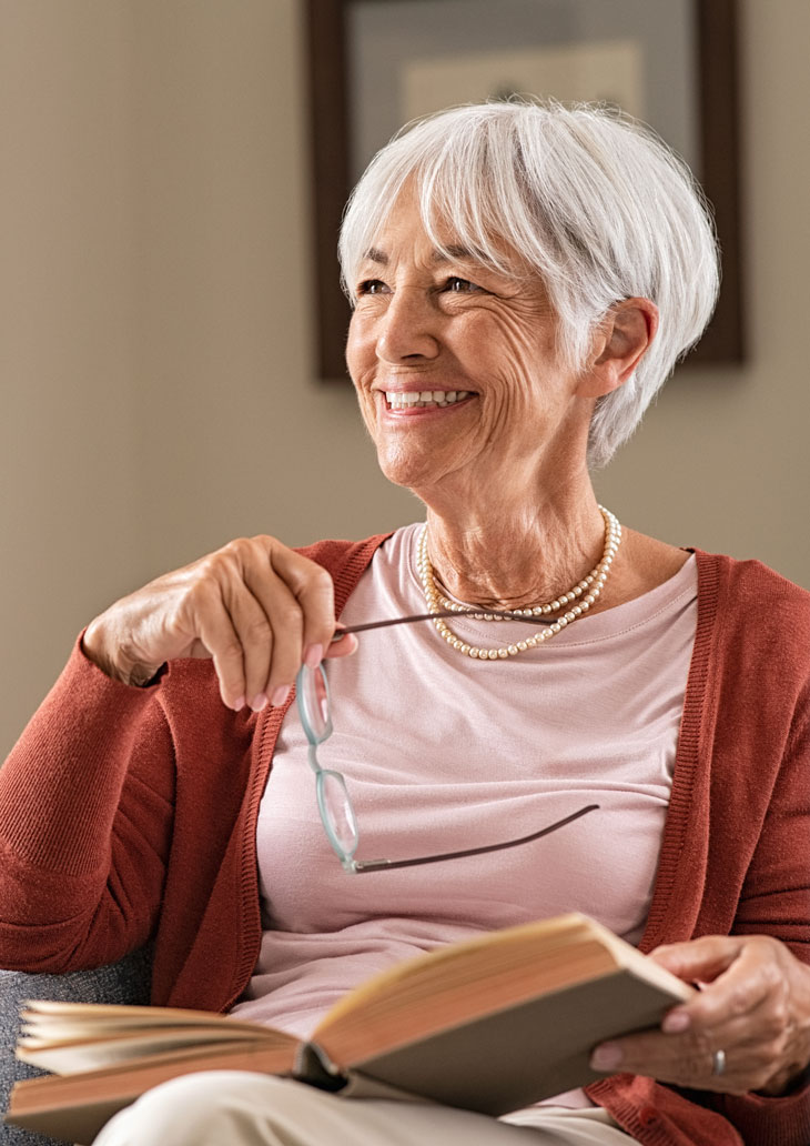 Woman reading a book on the couch