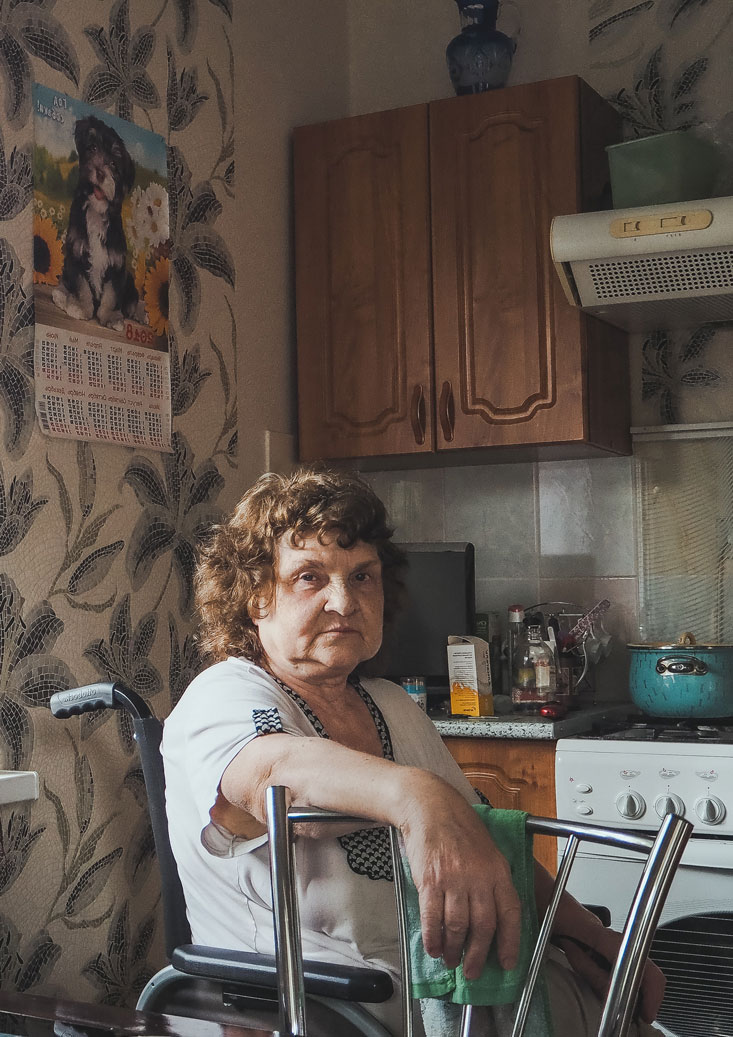 Senior woman sitting in her kitchen 