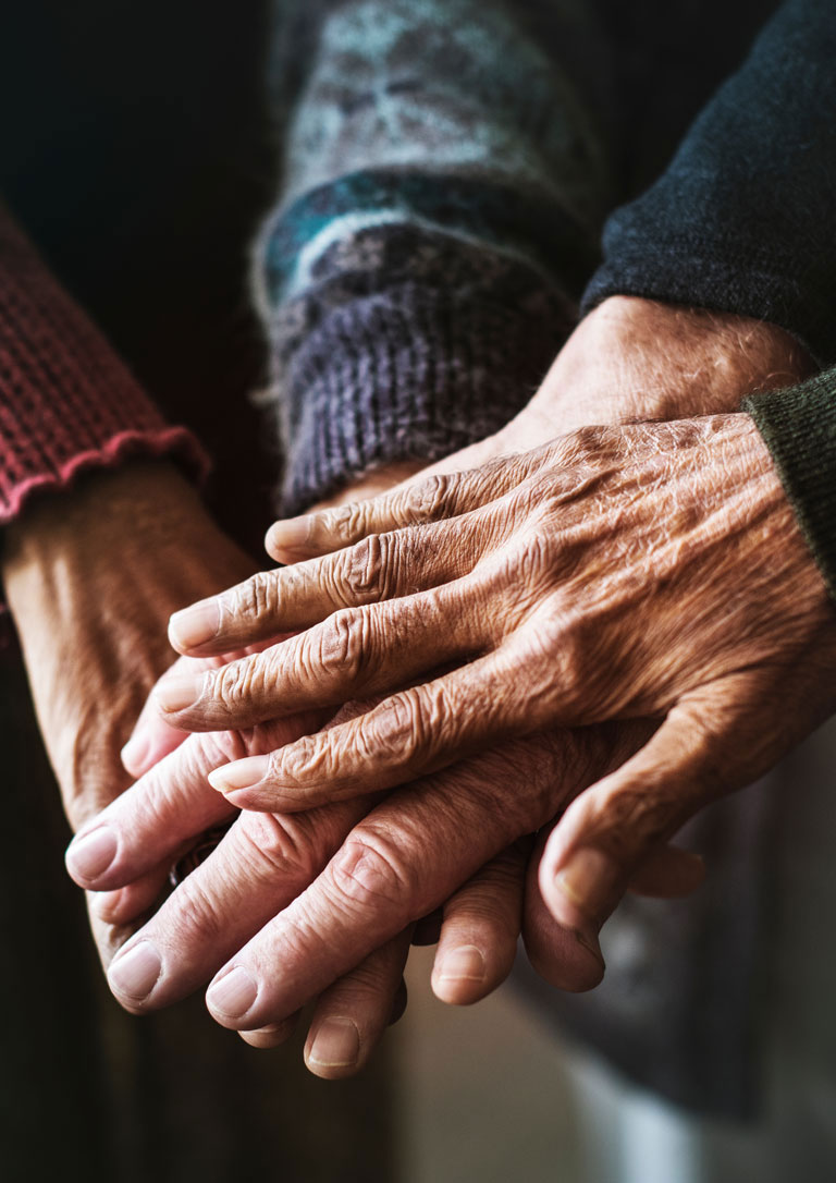 four senior peoples hands