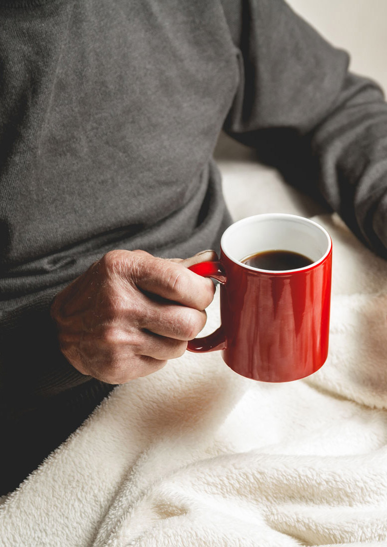 Elderly person with coffee