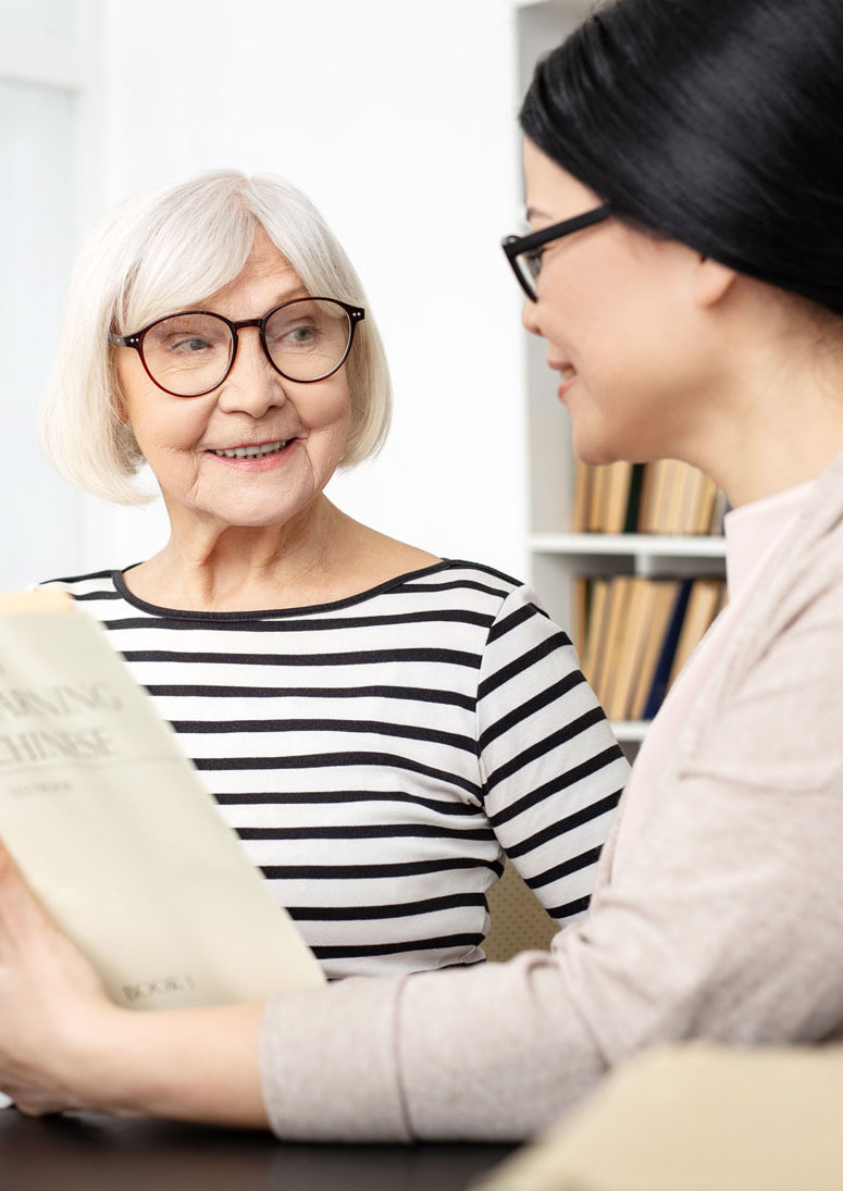 Young woman helping elderly woman