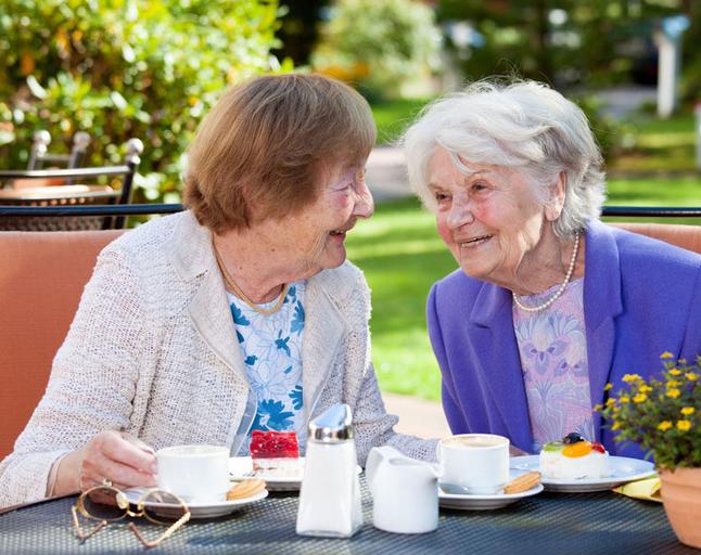 Two senior women having tea