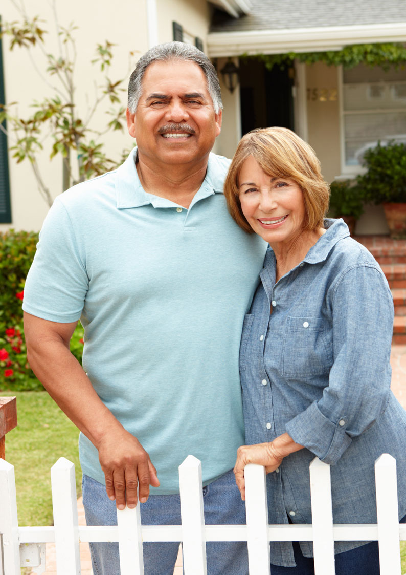 Couple standing out the front of their house 