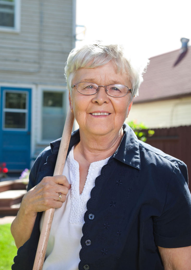 Woman in backyard smiling at camera