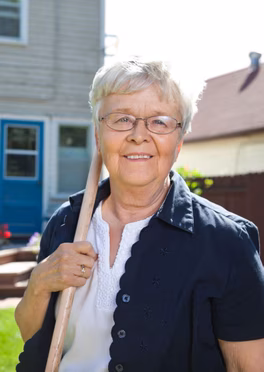 Woman in backyard smiling at camera