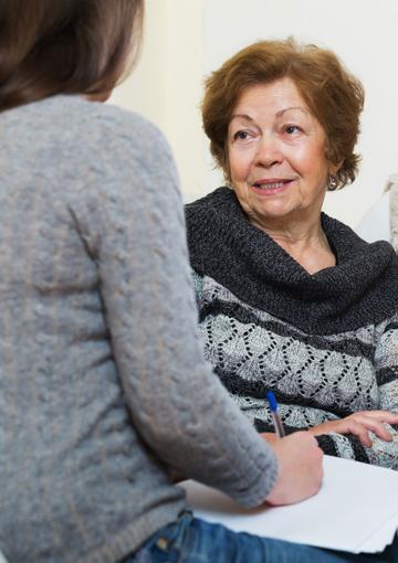Senior woman talking to support person 