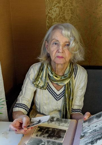 Senior woman looking at old photos