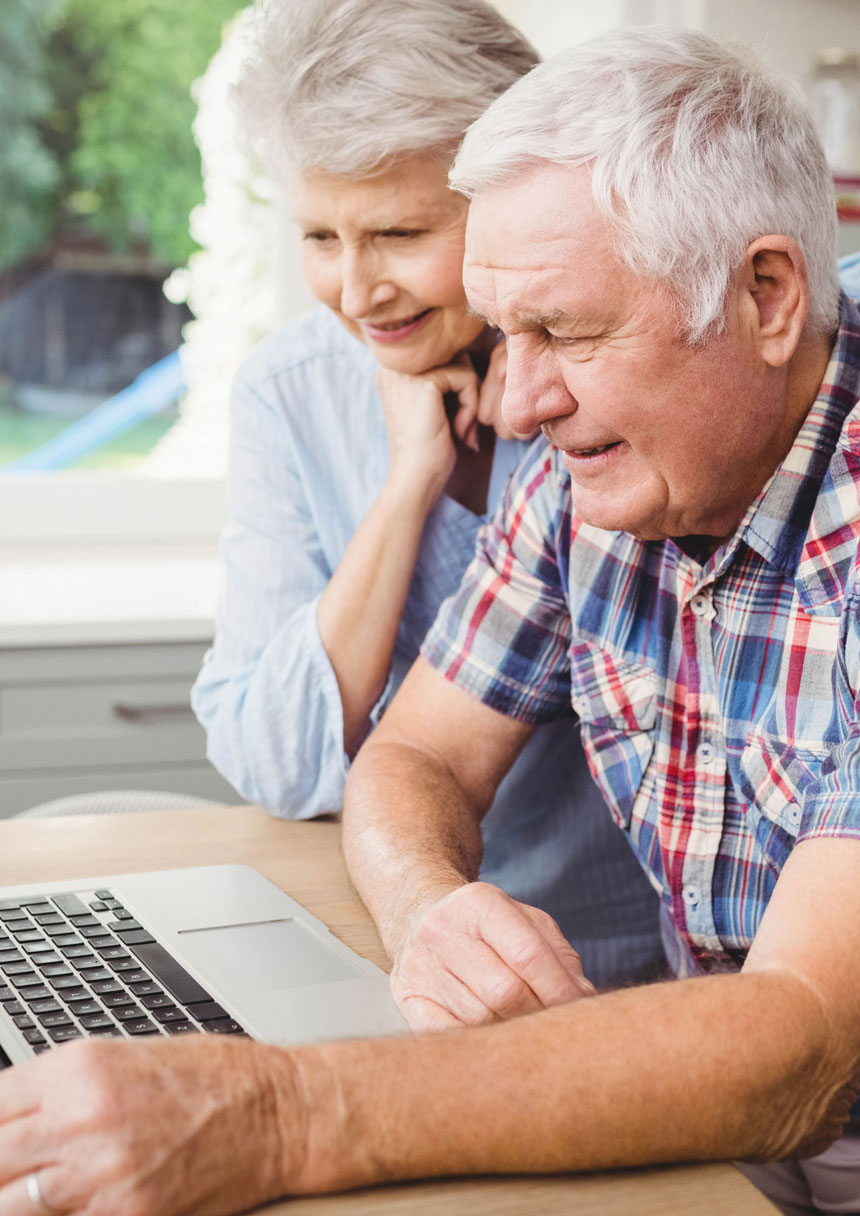Senior couple looking at laptop 
