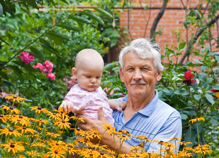Grandfather and grandchild in the garden