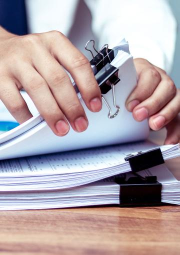 Stack of reports on a desk 