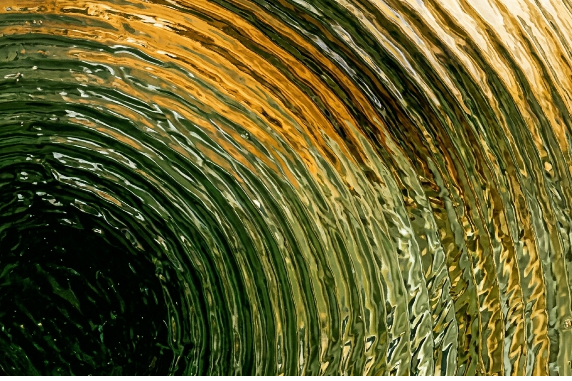 Close-up of textured concentric circles in shades of green and gold, creating a ripple effect like swirling water or a metallic surface.