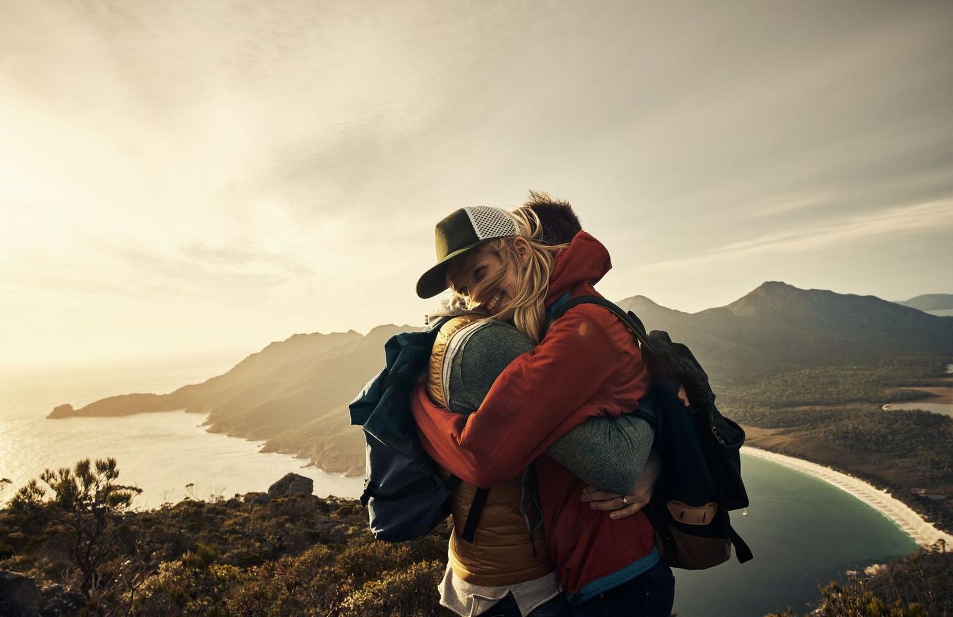 2 people hugging outside