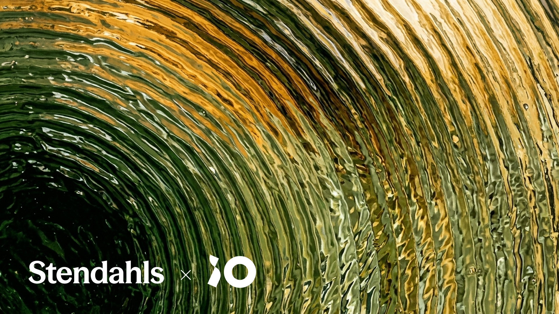 Close-up of swirling green and yellow glass waves with "Stendahls x IO" text in white at the bottom left.