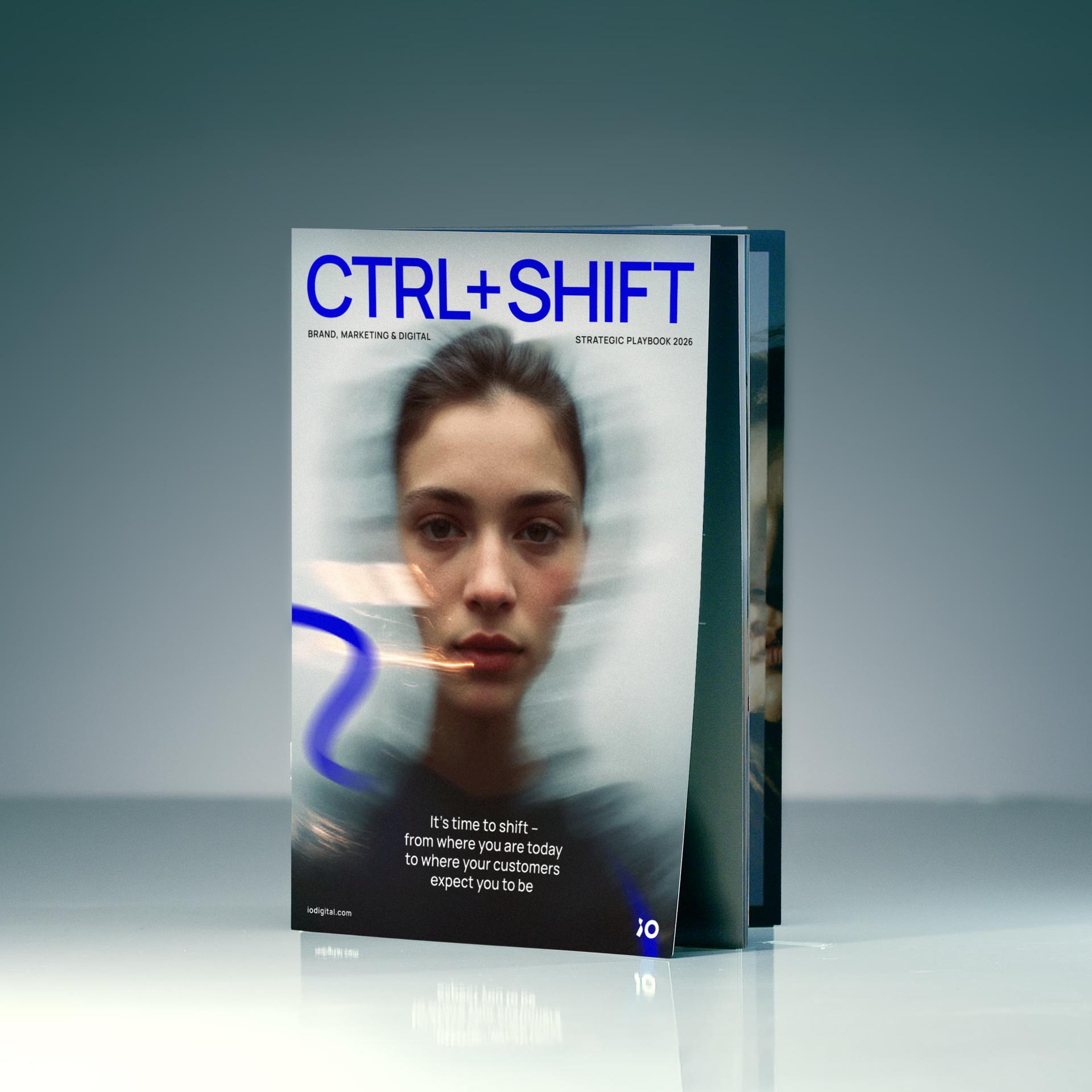 Magazine titled "CTRL+SHIFT" with a blurred image of a woman's face on the cover, focusing on brand marketing and digital strategy.