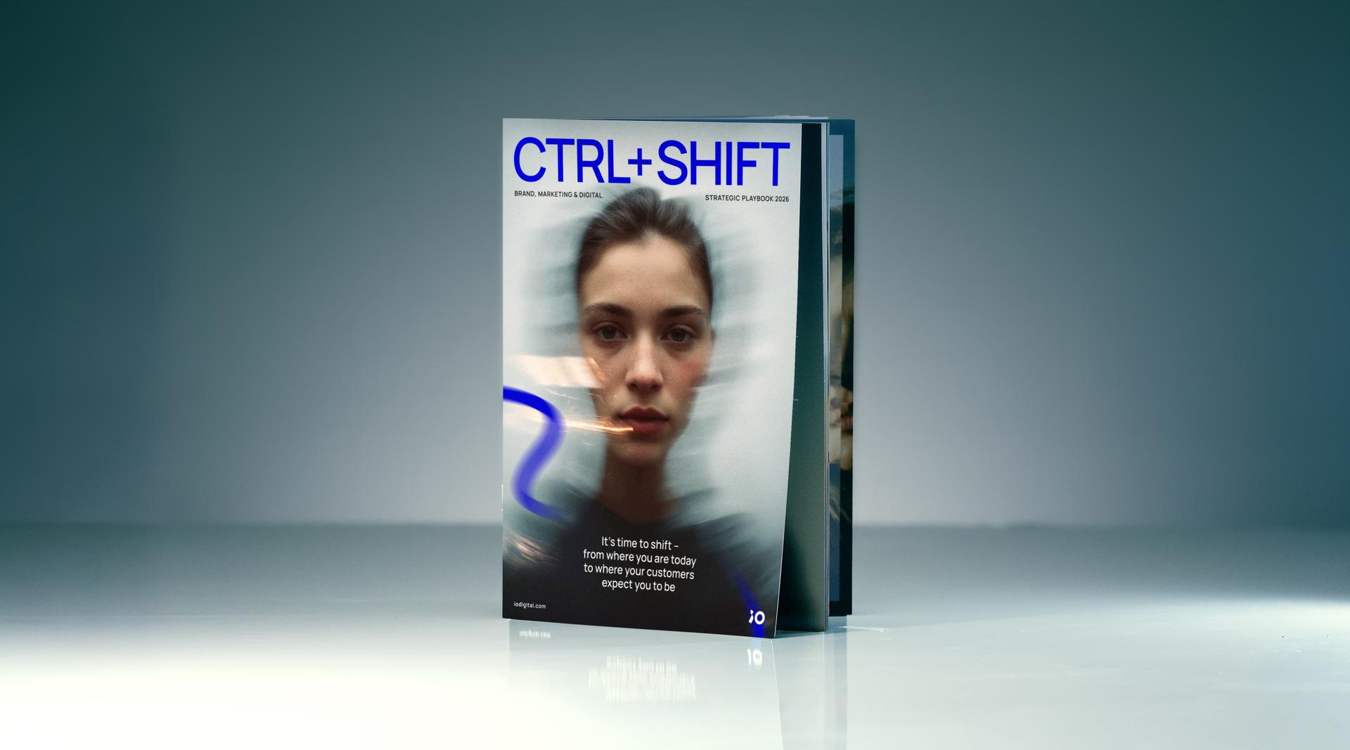 Magazine titled "CTRL+SHIFT" with a blurred image of a woman's face on the cover, reflecting a modern, digital theme.