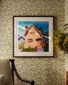 frame print of a house on a wall with patterned green wallpaper frame print of a house on a wall with patterned green wallpaper