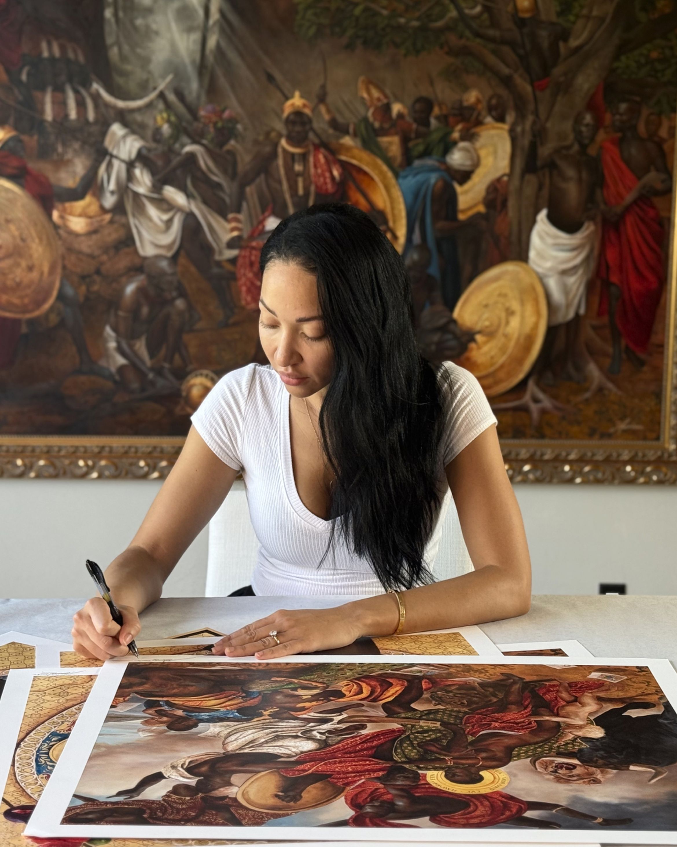 Harmonia Rosales signing her new limited edition print