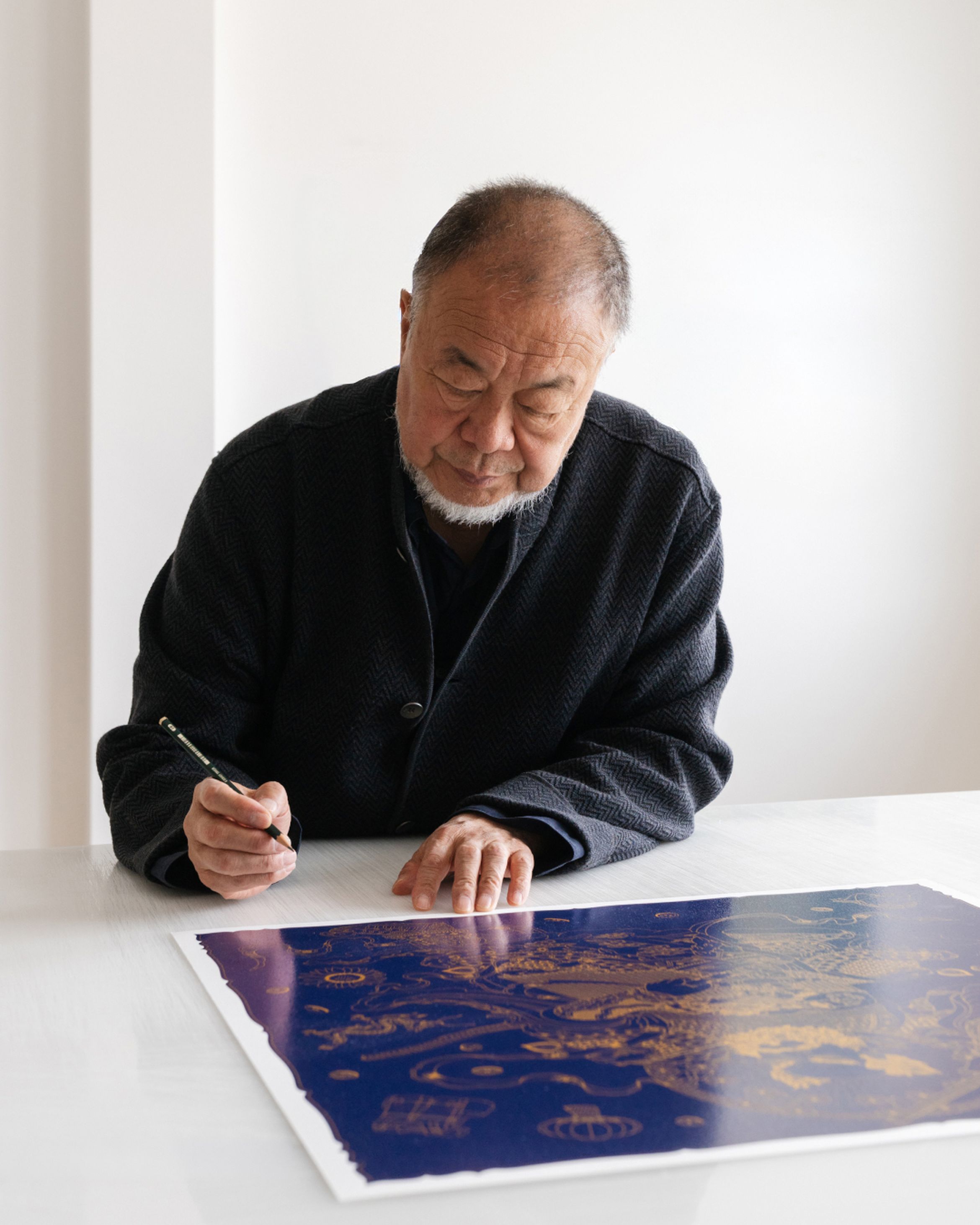 Ai Weiwei signing his latest limited edition silkscreen print
