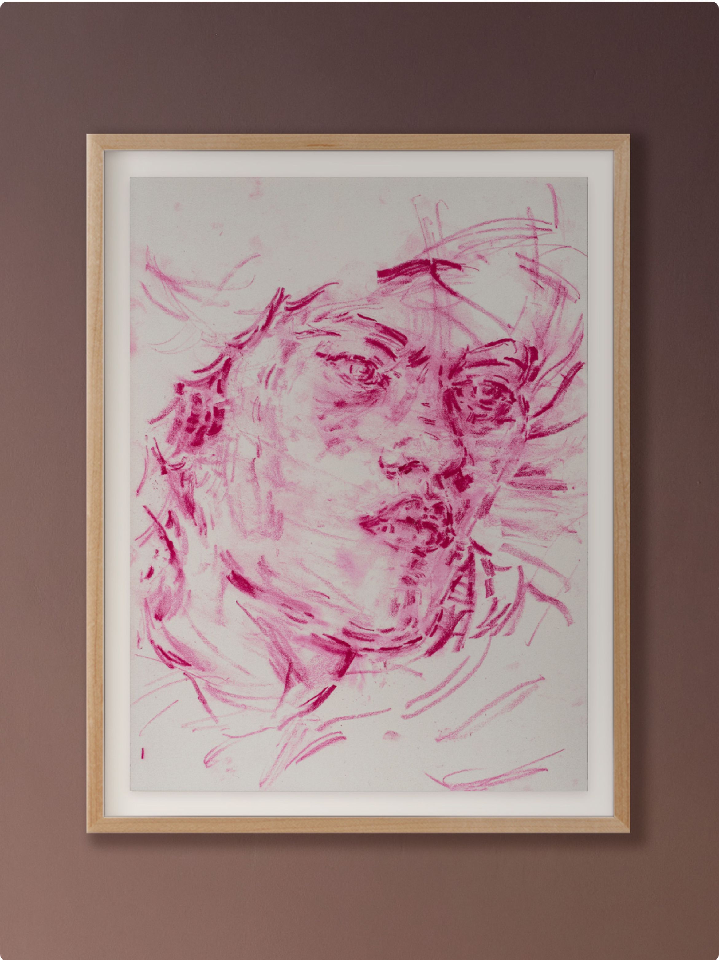Framed abstract portrait in pink tones on a white background, featuring expressive lines and brushstrokes, hung on a brown wall.