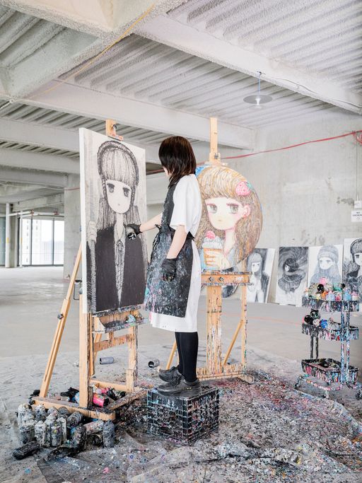 Stickymonger standing on a stool working on a painting on an easel Stickymonger standing on a stool working on a painting on an easel