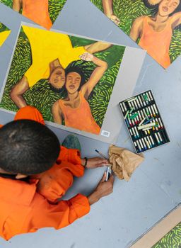 Artist Sola Oluloede hand-finishing her print in her studio - close up Artist Sola Oluloede hand-finishing her print in her studio - close up