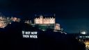 "If not now then when" projected onto the cliff face below Edinburgh Castle in block capitals "If not now then when" projected onto the cliff face below Edinburgh Castle in block capitals