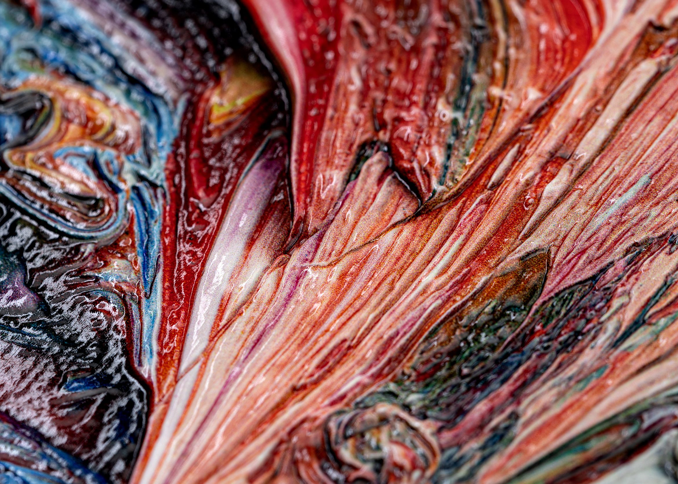 Close up of red blue orange and pink colourful textured print that looks like brushstrokes