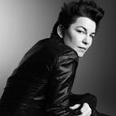 a black and white photograph of artist Elizabeth Peyton wearing a black jacket