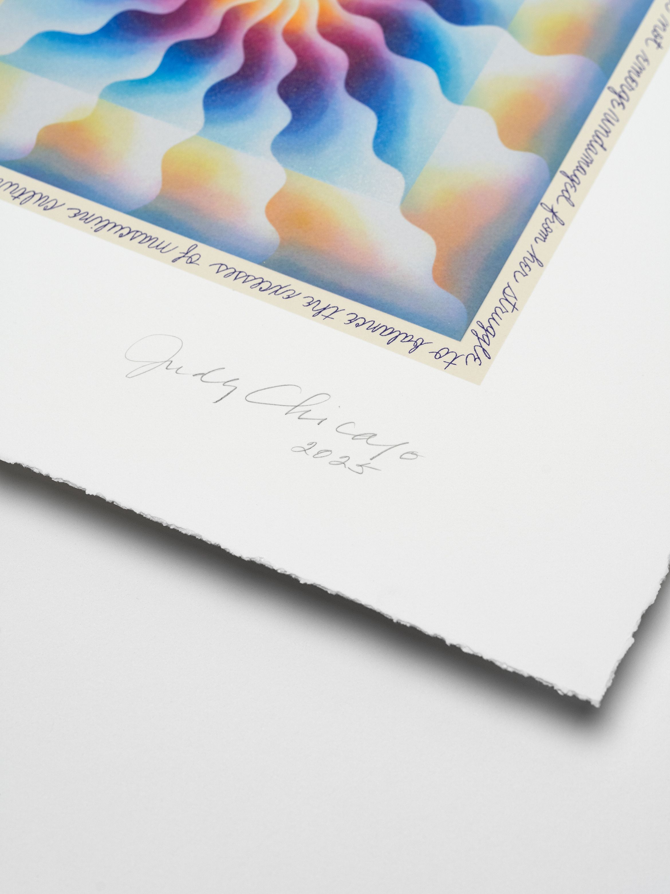 Colorful abstract artwork with wavy patterns on a white sheet, featuring a signature and the year 2025 at the bottom.