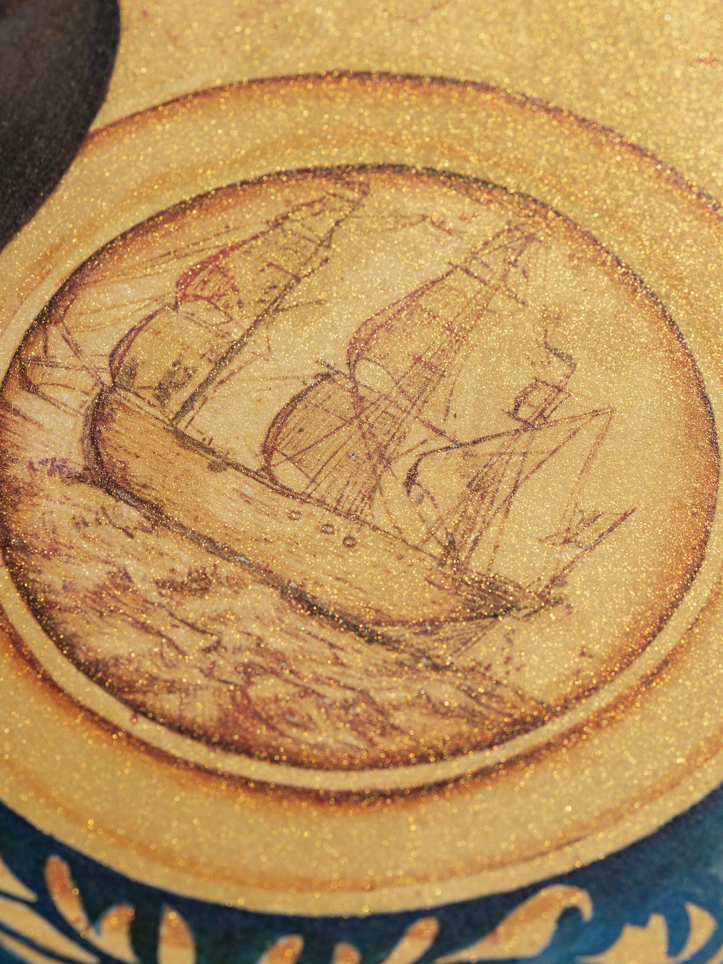 Close-up of a sailing ship on a textured, circular background with golden hues and intricate detailing.
