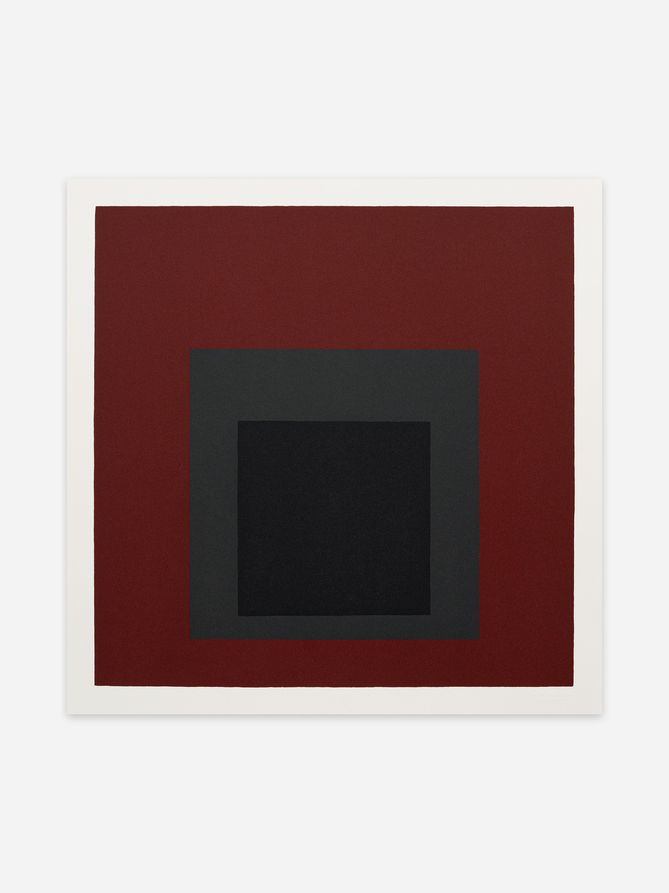 Abstract art with concentric squares: a black square inside a grey one, surrounded by a larger dark red square on a white background.
