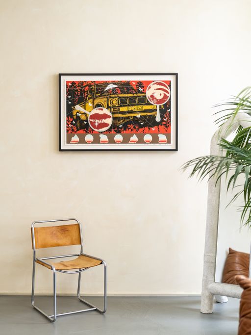 a framed print edition by Jaime Munoz photographed hung on a white wall above a chair a framed print edition by Jaime Munoz photographed hung on a white wall above a chair