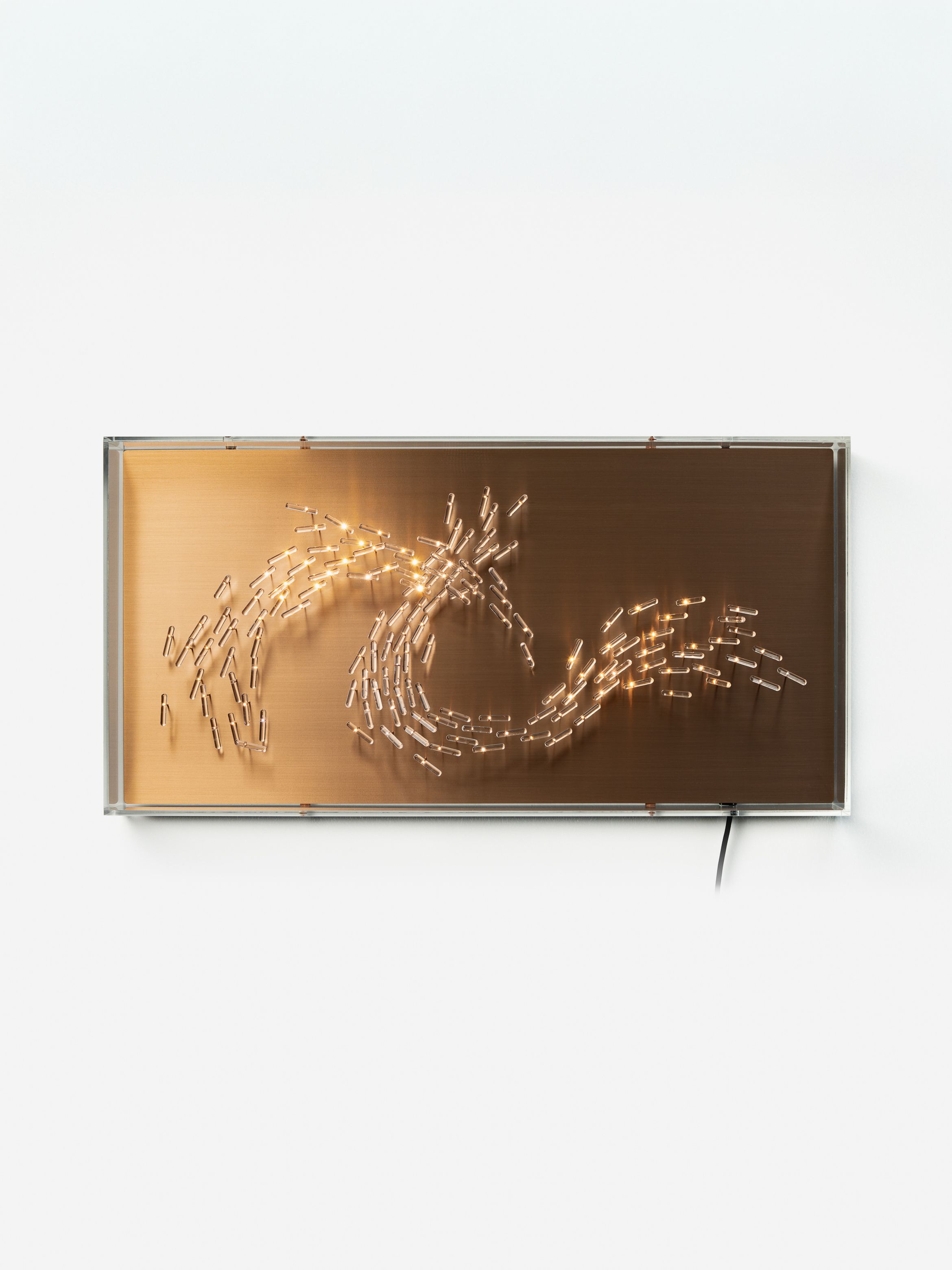 Bronze-coloured rectangular panel with light bulbs arranged in a swirling wave pattern, mounted against a plain white background.