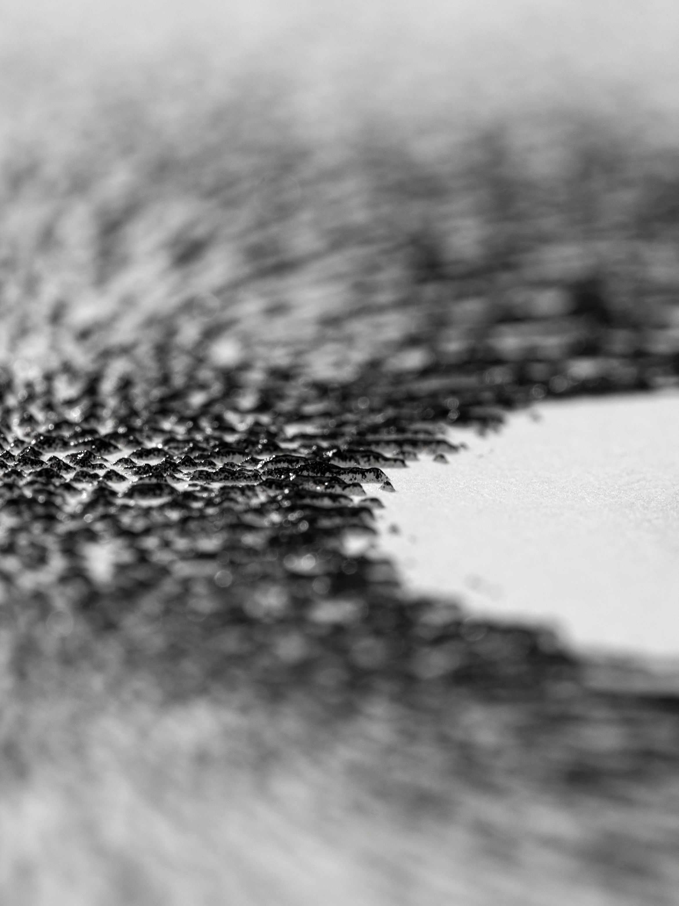 On-angle detail of a textured archival pigment by Ahmed Mater