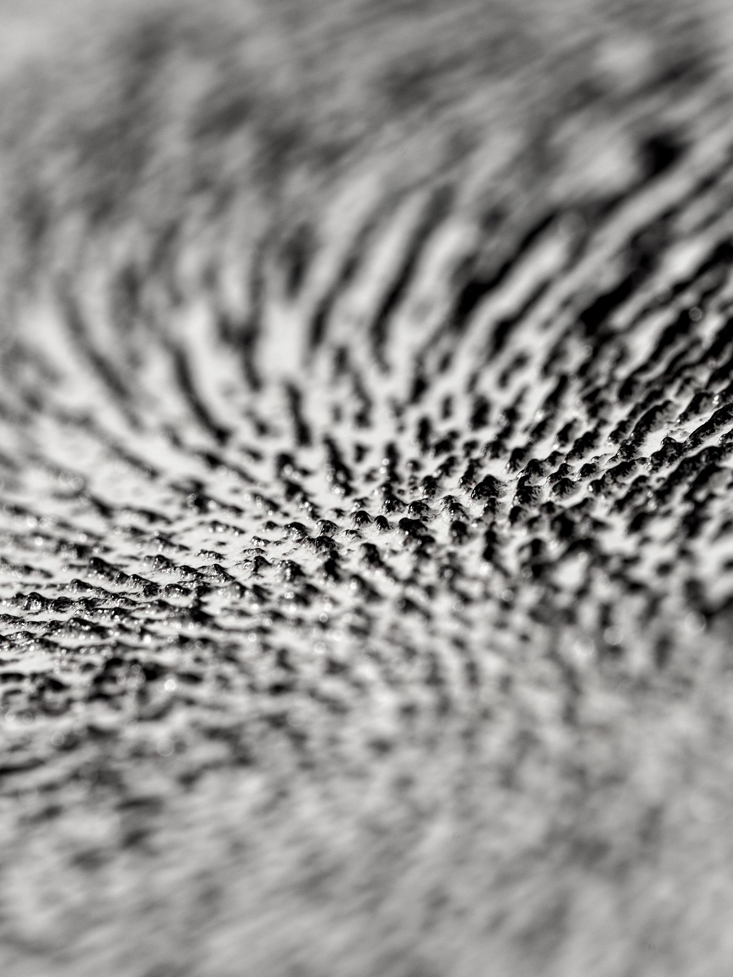 On-angle detail of a textured archival pigment by Ahmed Mater